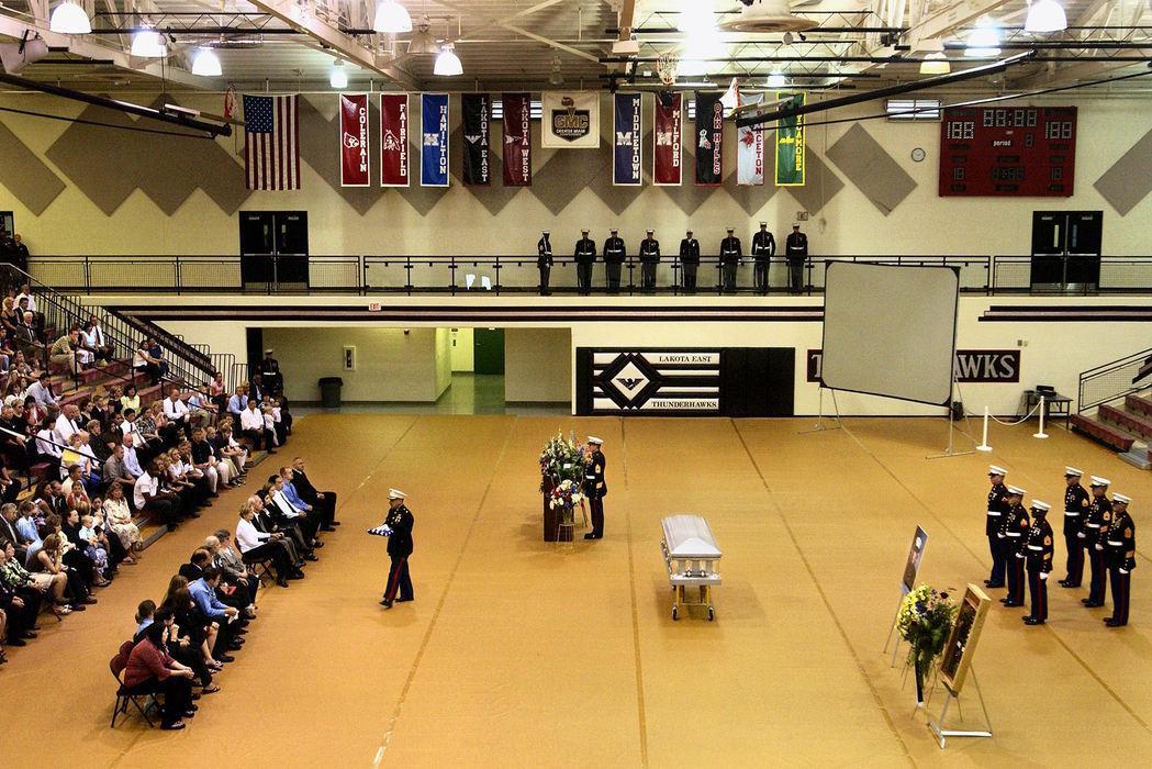 Second Place, George S. Smallsreed Photographer of the Year Award - Greg Ruffing / FreelanceThe American flag from the casket of Lance Cpl. Timothy Bell Jr. is presented to his family during a public memorial service in the gymnasium at his alma mater, Lakota East High School in West Chester.