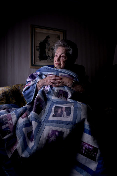 First place, George S. Smallsreed Photographer of the Year Award - Mike Levy / The Plain DealerSylvia Malcmacher holocaust survivor with her quilt that contains family photo images.