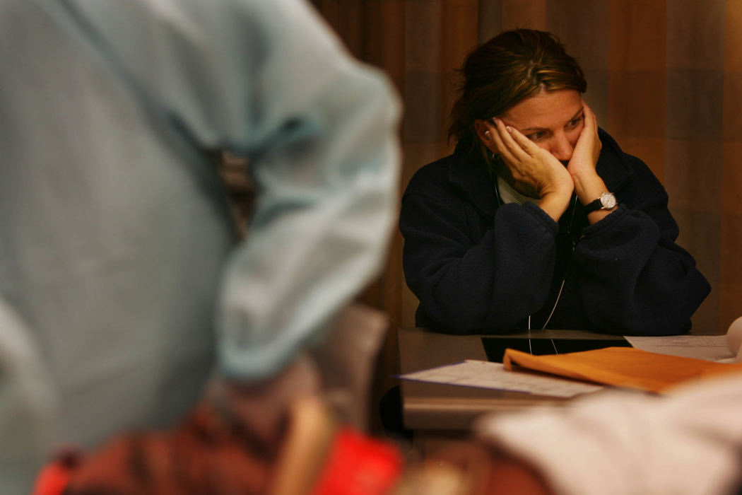 Third Place, George S. Smallsreed Photographer of the Year Award - Gus Chan / The Plain DealerA nurse is lost in her thoughts during treatment of a patient.