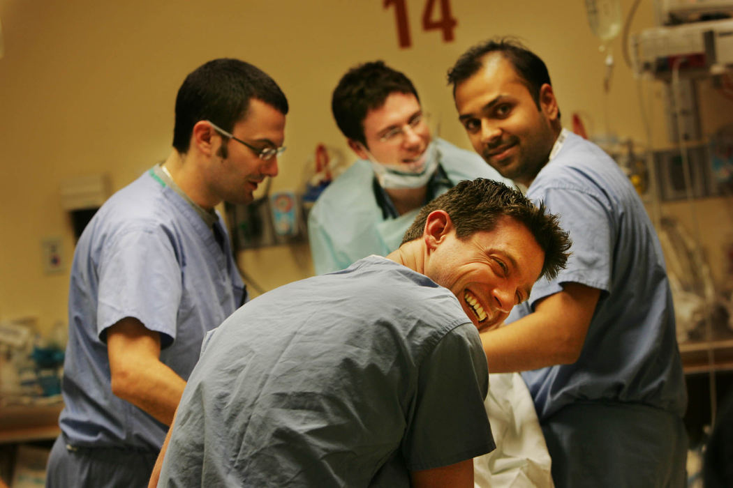 Third Place, George S. Smallsreed Photographer of the Year Award - Gus Chan / The Plain DealerResidents share a laugh as they tend to a drunken patient.