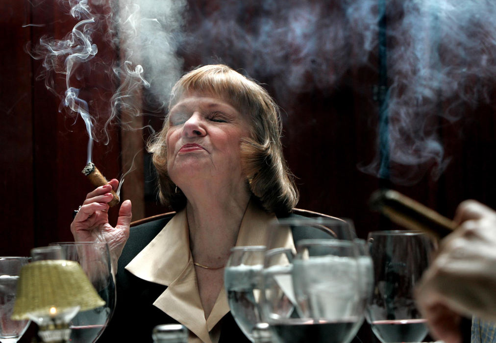 Award of Excellence, Portrait/Personality - Fred Squillante / The Columbus DispatchCandy Batross of Clintonville enjoys a good smoke at Morton's steakhouse's last cigar dinner. The 13-year tradition of cigar dinners was coming to an end due to a new Columbus law to take effect banning smoking inside public places.