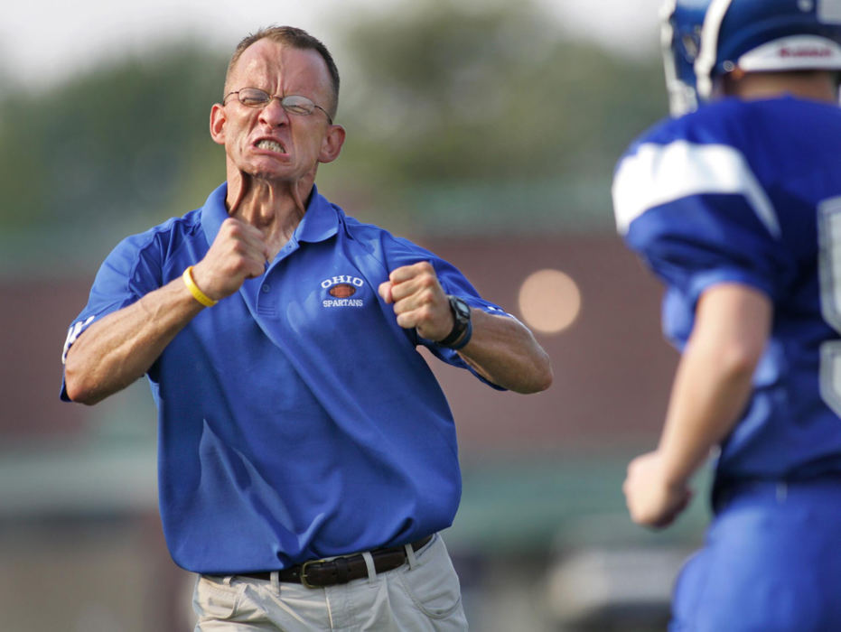 Second Place, Sports Feature - Fred Squillante / The Columbus DispatchOhio School for the Deaf Spartans head coach Bill Estes shows the kind of intensity he wants out of player Donald Garber (right) as he sends Garber in to play. Coach Estes, who is also deaf, has to communicate with his players through sign language and the intensity of his expressions. In 2005, the Ohio School for the Deaf fielded a football team for the first time in 44 years. 