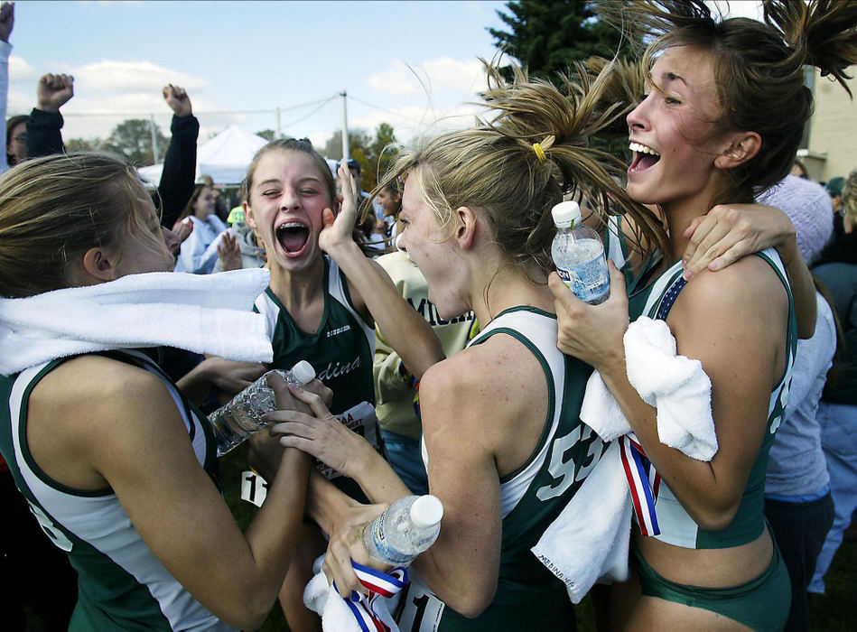 Third Place, Sports Feature - Andy Wrobel / Medina GazetteMedina High School's cross country team reacts after hearing, over the loudspeaker, the news that the team finished third in the regional meet at Boardman High School on Oct. 29, 2005, and would qualify for the state tournament in Columbus. From left are Chrissy Vorst, Colleen Kelly, Kelly Pickering and Mikaela Foreit.