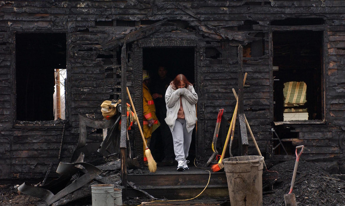 First Place, Spot News over 100,000 - Dale Omori / The Plain DealerWendy Brubaker leaves her burned out home after talking with state fire marshals about an early morning fire that killed her youngest two daughters. Her two older daughters and husband survived the fire.