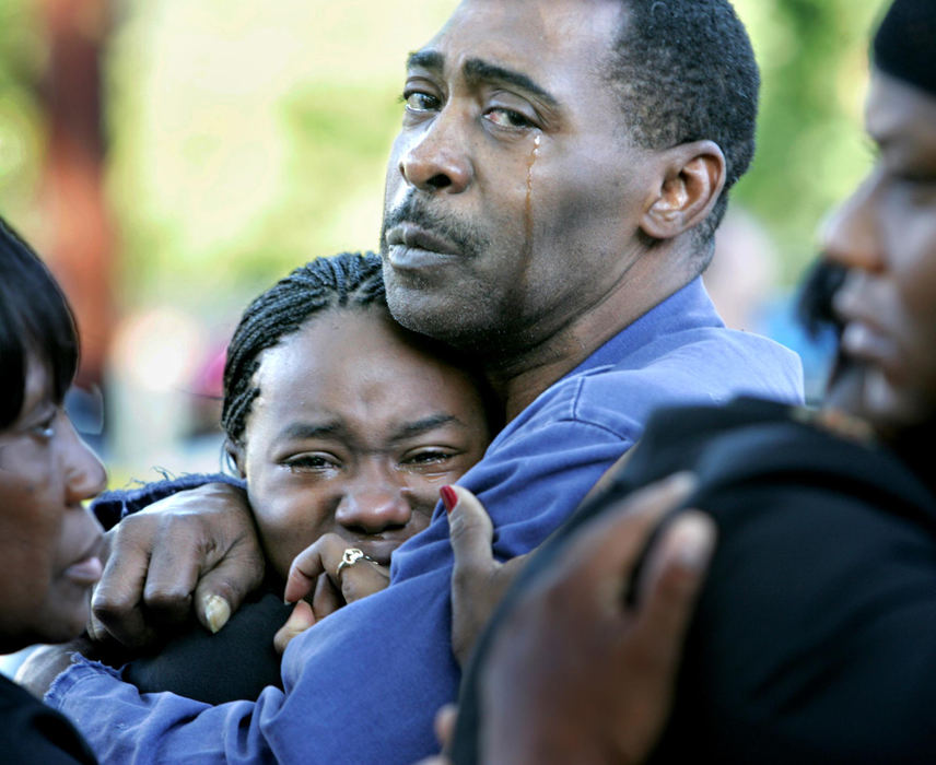 Award of Excellence, Spot News over 100,000 - David I. Andersen / The Plain DealerWillie Chappell, uncle of Brandon McCloud, hugs Brandon's sister Lacole Harris, 19, after the coroner's van carrying Brandon's body drove by.  Brandon, 17,  was killed by Cleveland Police while they were serving a search warrant for his arrest on a string of armed robberies.