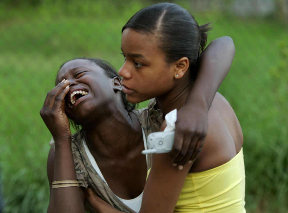 Award of Excellence, Spot News over 100,000 - Marvin Fong / The Plain DealerMary Curry (right) comforts Shanaye Cook  at the scene of a house fire that killed nine people on E. 87th street in Cleveland. 