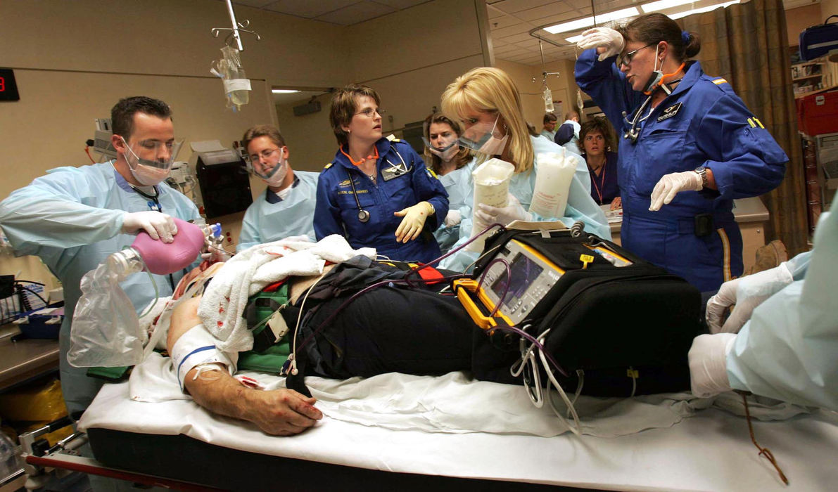 Award of Excellence, Student Photographer of the Year Award - Sung H. Jun  / Ohio UniversityMetroHealth Medical Center's trauma team surrounds a patient as soon as Clewell and Lorenz wheel him into the Emergency Department. An hour later, the director of Metro's ICU, Dr. Joel Peerless, comes looking for Lorenz. "I can't believe you got that (airway) tube in, Lisa," Peerless tells her. "You saved his life. You really did."