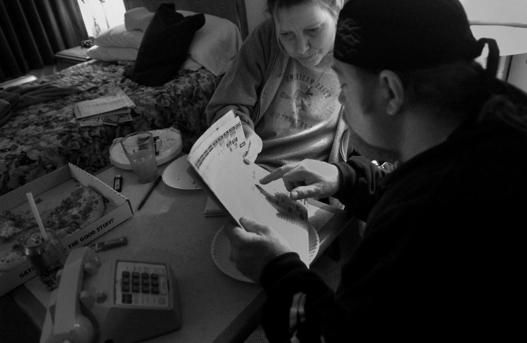 Award of Excellence, Student Photographer of the Year Award - Sung H. Jun  / Ohio UniversityRebecca Valentine and her boyfriend, Tony Mitchell, look over the classified ads in a newspaper to find a used couch. The couple stayed in a motel, HomeLife Studio&Suites, for five weeks after they lost their home in the Nov. 6th tornado.    