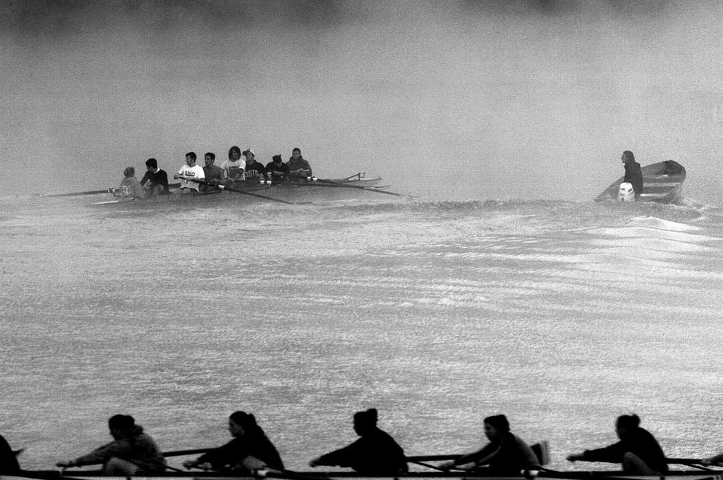 First place, Student Photographer of the Year Award - Katie Falkenberg / Ohio UniversityEarly morning fog lingers over Dow Lake as the Ohio University men’s crew team receives coaching tips, and the women’s varsity team rows by, at Stroud’s Run State Park in Athens, Ohio.  Both teams practice every other morning beginning at 5:45.