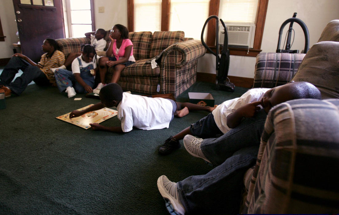 Second Place, Student Photographer of the Year Award - Emily Rasinski / Kent State UniversityThe kids play a game that was donated to the family and watch TV to pass the time during the day before they are enrolled in school.  The 11 members of the Ballard family are staying with their cousin Michael Franks and his son until they are able to get a home of their own.