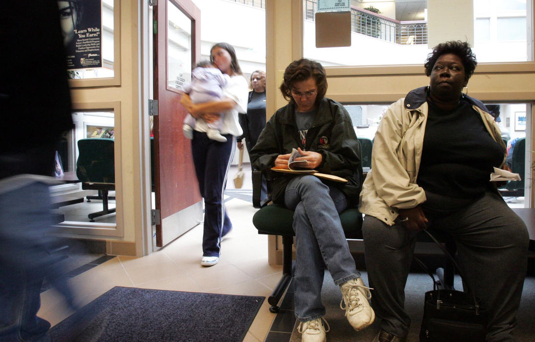 Second Place, Student Photographer of the Year Award - Emily Rasinski / Kent State UniversityClaudia Ballard waits in the Akron Metropolitan Housing Authority to apply for section 8 housing.  This will allow her family to move into their own house.