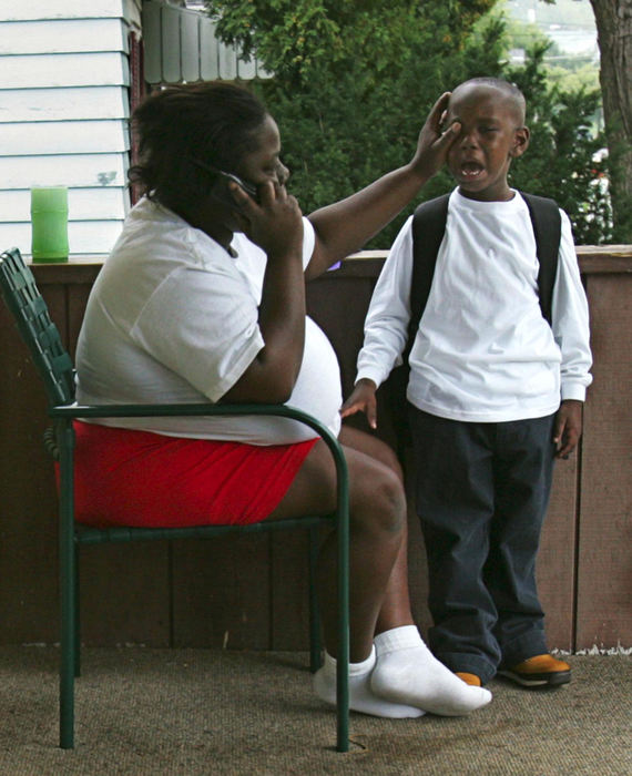 Second Place, Student Photographer of the Year Award - Emily Rasinski / Kent State UniversityClaudia Ballard wipes the tears from the eyes of her five-year-old son Kevon as he gets ready for his first day of school in Akron.  Kevon had only attended one day of kindergarten in New Orleans before his school was closed.