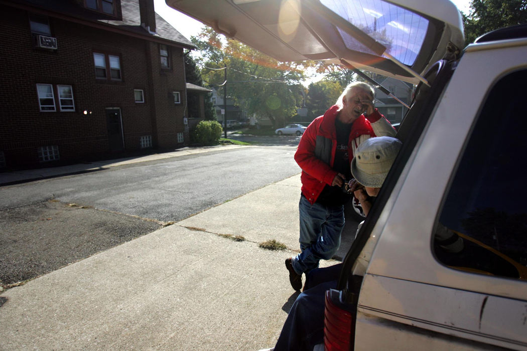 Second Place, Student Photographer of the Year Award - Emily Rasinski / Kent State UniversityJoseph and Joey take a break after fixing the back light on their 13-year-old van in the parking lot of the Family Center.  The van served as their home for about a month.