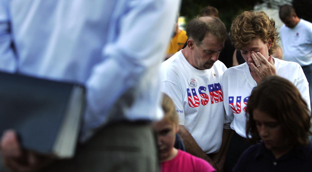 Second Place, Student Photographer of the Year Award - Emily Rasinski / Kent State UniversityEdie Deyarmin wipes a tear from her eye as she stands with her husband  Daniel Nathan Deyarmin Sr. at a 9-11 remembrance ceremony at Tallmadge Circle. A special candle was dedicated to their son Nathan Deymarin, a marine who was killed earlier this year in Iraq. 