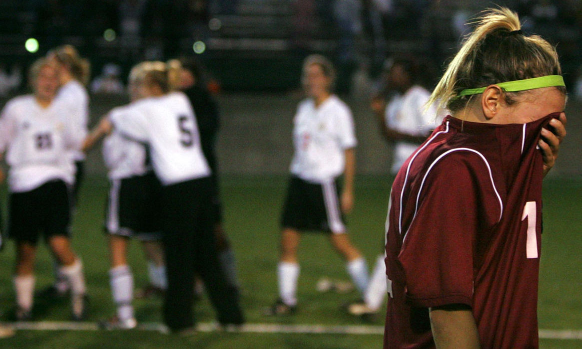 Second Place, Student Photographer of the Year Award - Emily Rasinski / Kent State UniversityDisappointed Walsh senior Brittany Valentine covers her face as Green celebrates their victory behind her. Green beat nationally ranked Walsh in double overtime 2-1, November 5, 2005. 