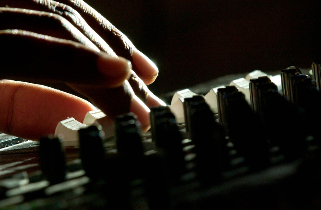 Third Place, Student Photographer of the Year Award - Michael P. King / Ohio UniversityMusic director DeeJay Roberts adjusts the controls on the soundboard during rehearsal April 12, 2005. All the music in the production is original.