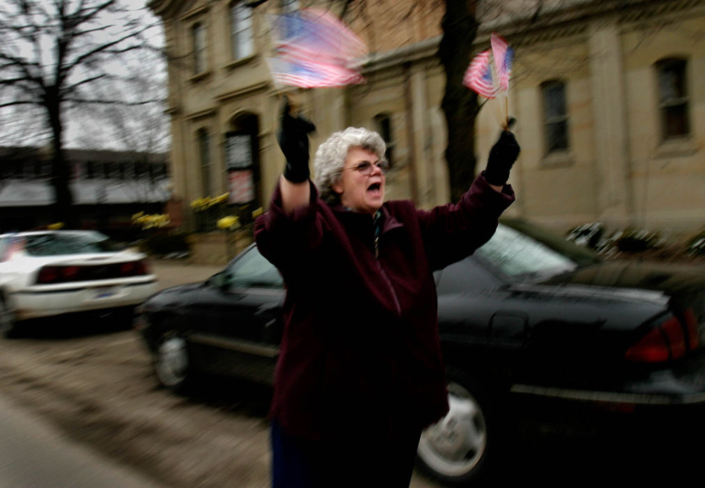 Third Place, Student Photographer of the Year Award - Michael P. King / Ohio UniversityBonnie Evans of Richmondale shows her patriotism in support of the returning soldiers of the Ohio National Guard 216th Engineer Battalion Alpha Company along Main Street in Chillicothe on Feb. 11, 2005. Evans cheered to reciprocate the welcome her own son received when he returned home to Chillicothe a year prior after serving in Iraq with the Army Reserve's 1001st.