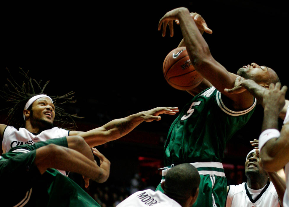 Third Place, Student Photographer of the Year Award - Michael P. King / Ohio UniversityFrom left, Cincinnati's Cedric McGowan, Chadd Moore, Ohio's Leon Williams, and Cincinnati's Ronald Allen scrap for a rebound in the first half of a game at Fifth Third Arena in Cincinnati, Dec. 14, 2005.