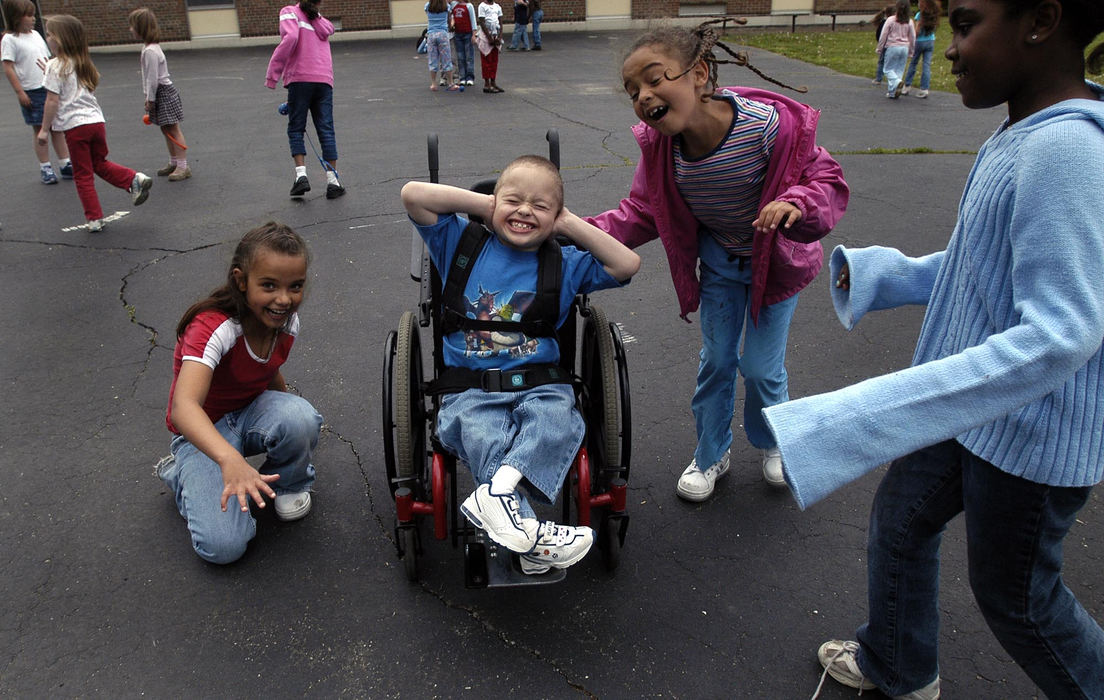 Award of Excellence, Student Photographer of the Year Award - Sung H. Jun  / Ohio UniversityJacob Brancheau, 7, plays with friends during lunch break at school. Brancheau has a lot of friends due to his outgoing and cheerful character. He has sacral agenesis, a congenital disorder characterized by an abnormal development of the lower spine that occurs in a developing fetus. Although not life-threatening, the condition makes walking impossible, but he is a baseball player.