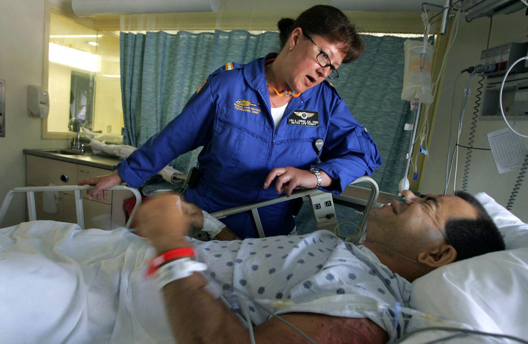 Award of Excellence, Student Photographer of the Year Award - Sung H. Jun  / Ohio UniversityMetro Life Flight Resident Nurse specialist, Lisa A. Lorenz, visits Dan Milkovich who was rescued by her yesterday from motorcycle accident at the Metrohealth Hospital Intensive care unit, June 27, 2005. 