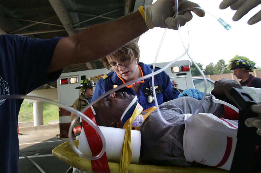Award of Excellence, Student Photographer of the Year Award - Sung H. Jun  / Ohio UniversityBy 5:10, physician, Sherry Clewell takes care of injured person from a car accident on I-90. The victim were suspected of shoplifting powdered baby formula from a Westlake grocery store. 