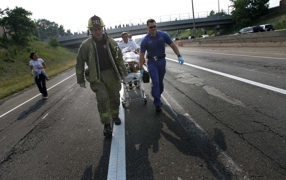 Award of Excellence, Student Photographer of the Year Award - Sung H. Jun  / Ohio UniversityFirefighters of Rock River and Metro Life Flight nurse specialist, Jason Welch, right, move a victim from a car accident to helicopter on I-90. 
