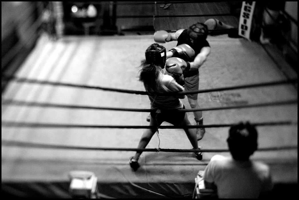Second Place, Sports Picture Story - Katie Falkenberg / Ohio UniversityThe men at the gym respect Jessica and usually treat her like one of them, allowing no mercy during a training fight; and new boxers, as well as veterans, will heed her advice on improving a technique.