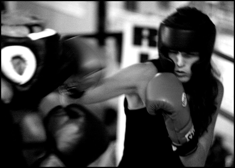 Second Place, Sports Picture Story - Katie Falkenberg / Ohio UniversityJessica goes in for the head punch as she fights a man during training.