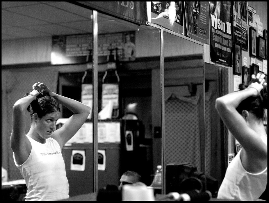 Second Place, Sports Picture Story - Katie Falkenberg / Ohio UniversityAs tough as she is, Jessica is still concerned with how she looks and fixes her hair in the gym’s mirror after leaving the ring.