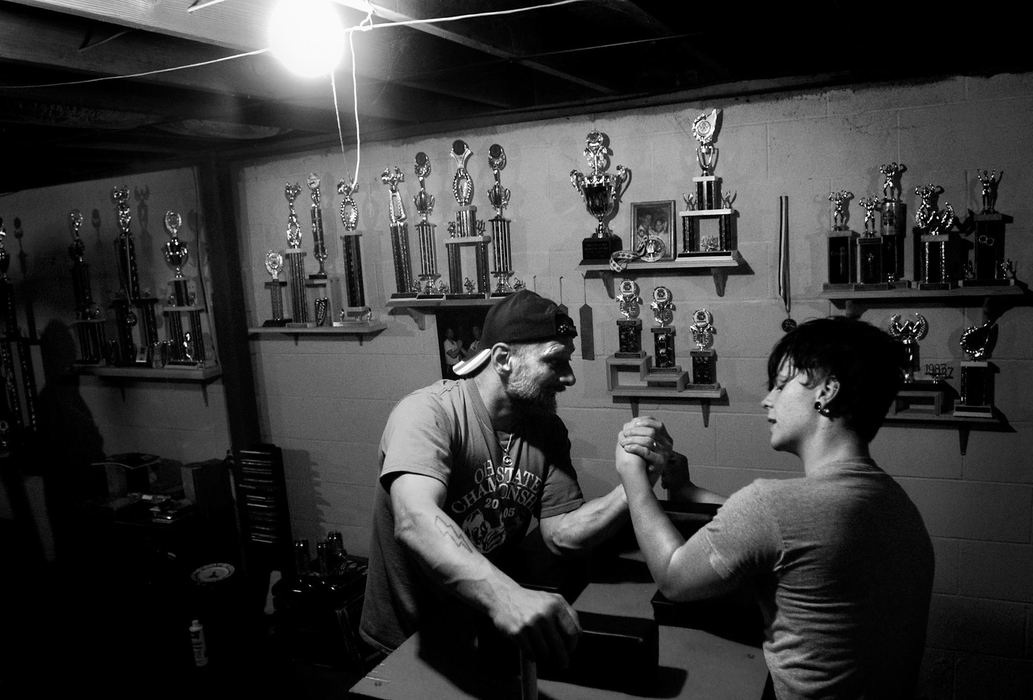 First place, Sports Picture Story - Greg Ruffing / FreelanceWillie Reagan, who began his professional arm wrestling career in 1983, is now passing along his championship tradition to his 19-year-old son Boomer. At age 14, Boomer began competing in youth divisions at tournaments. After a year of winning every youth tournament he entered, Boomer moved up and began competing against adults. The transition did not happen smoothly, and Boomer ended up losing most of his early matches to adults before finally winning his first adult tournament at age 16. Together, Willie and Boomer have become one of the most successful and well-respected father-son teams in professional arm wrestling. 