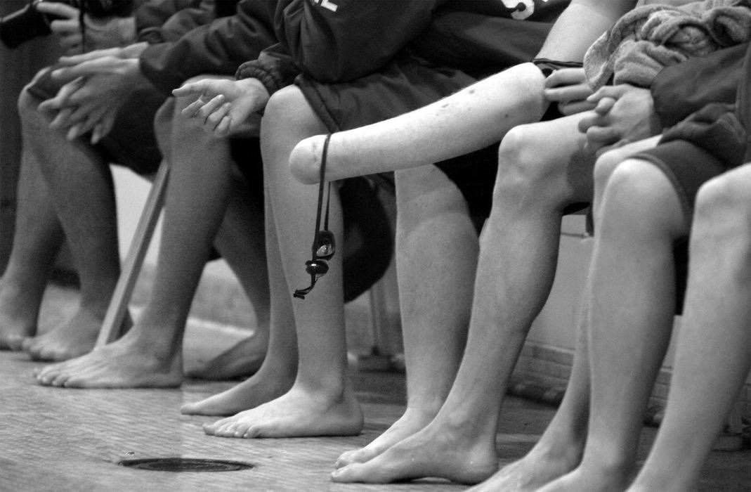 Third Place, Sports Picture Story - Abogail Bobrow / Sandusky RegisterDustin dangles his goggles on his stump while sitting with his teammates during a meet. 