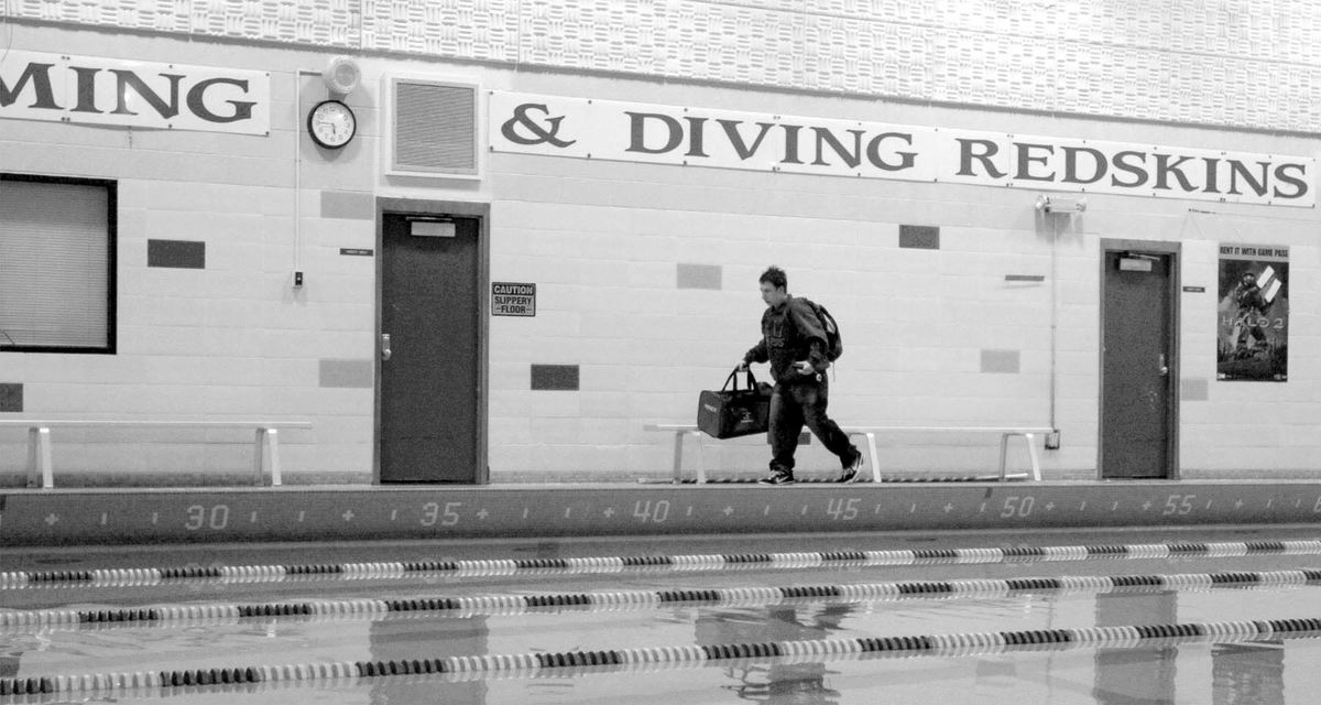 Third Place, Sports Picture Story - Abogail Bobrow / Sandusky RegisterDustin, wearing his prosthetic leg, walks past the pool after practice. 