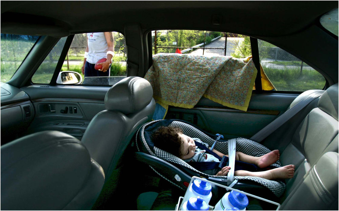 Award of Excellence, Sports Picture Story - Ed Suba, Jr. / Akron Beacon JournalChase Seams sleeps in the car as his father and Ohio Valley Bengal player, Scott Seams, prepares to practice with the semi-pro football team at Goodyear Middle School in Akron. The Ohio Valley Bengals team is a member of the semi-pro Ohio Valley Football League which was founded in 1966. 