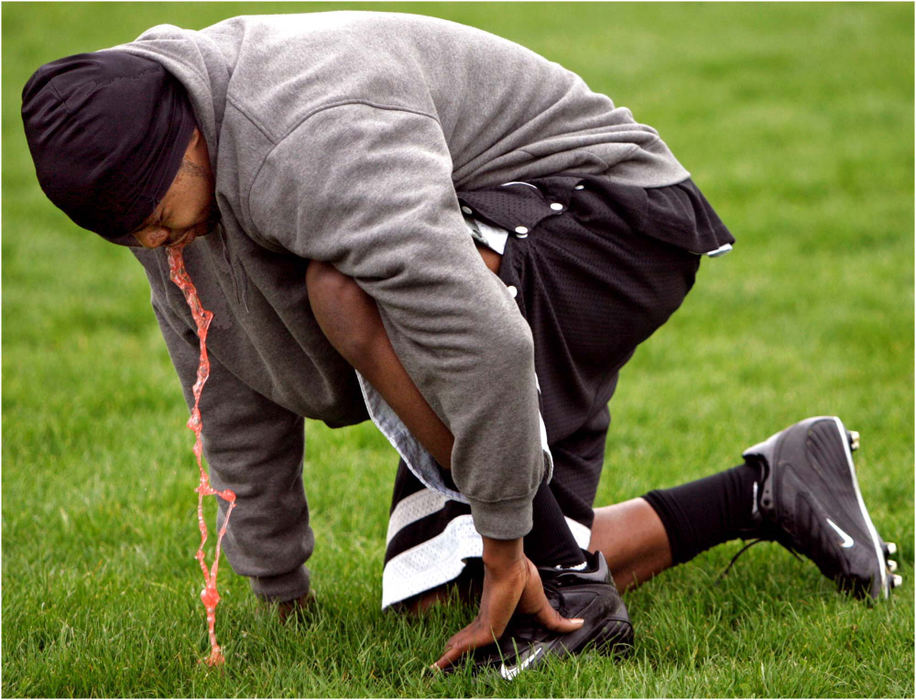 Award of Excellence, Sports Picture Story - Ed Suba, Jr. / Akron Beacon JournalBraving the cold temperatures and, like the majority of players on the team, woefully out of shape, Ohio Bengal player Dalvin Hill throws up during a team practice session. 