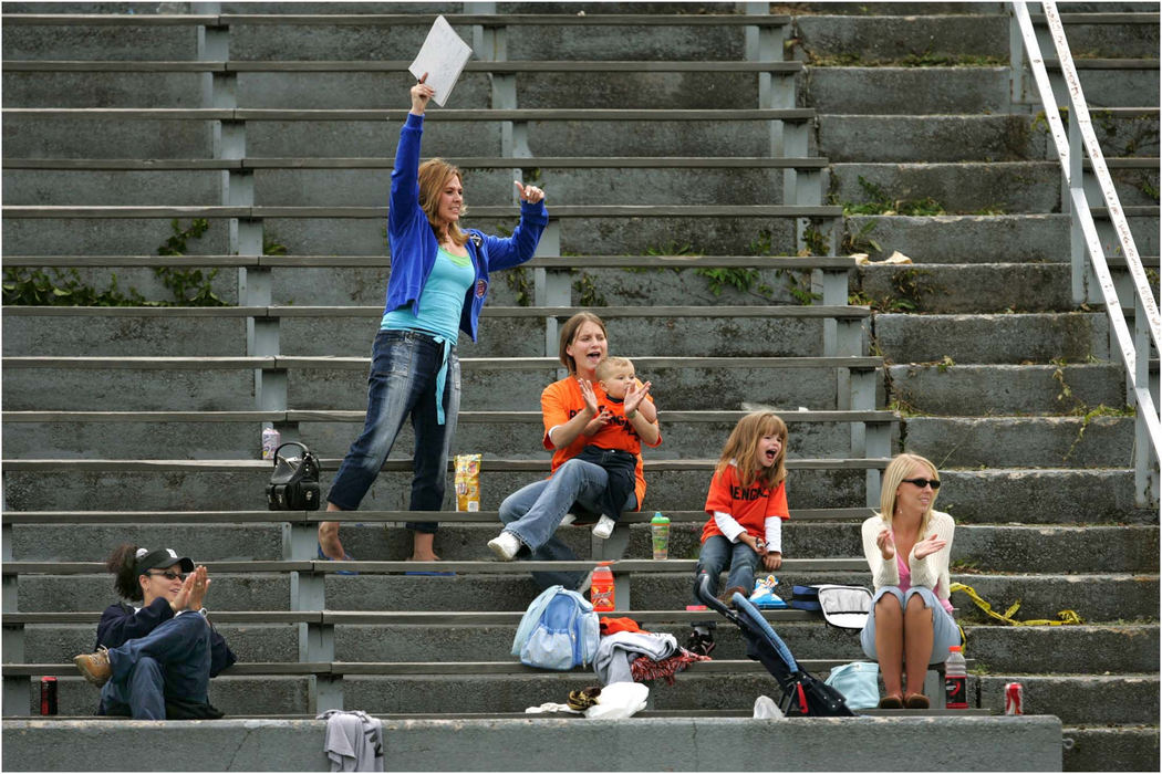 Award of Excellence, Sports Picture Story - Ed Suba, Jr. / Akron Beacon JournalSitting in a nearly empty stadium at Rayen High School (from left) Melissa Powers, owner Misty Brown, Amy Witt and her children, Eric, 1, and Ashley, 5, cheer on their team, the Ohio Valley Bengals, to a 44-7 victory over the Mahoning Valley Panthers in Youngstown. Crowds at the team's game were always small and mostly made up of the same small group of family and friends.