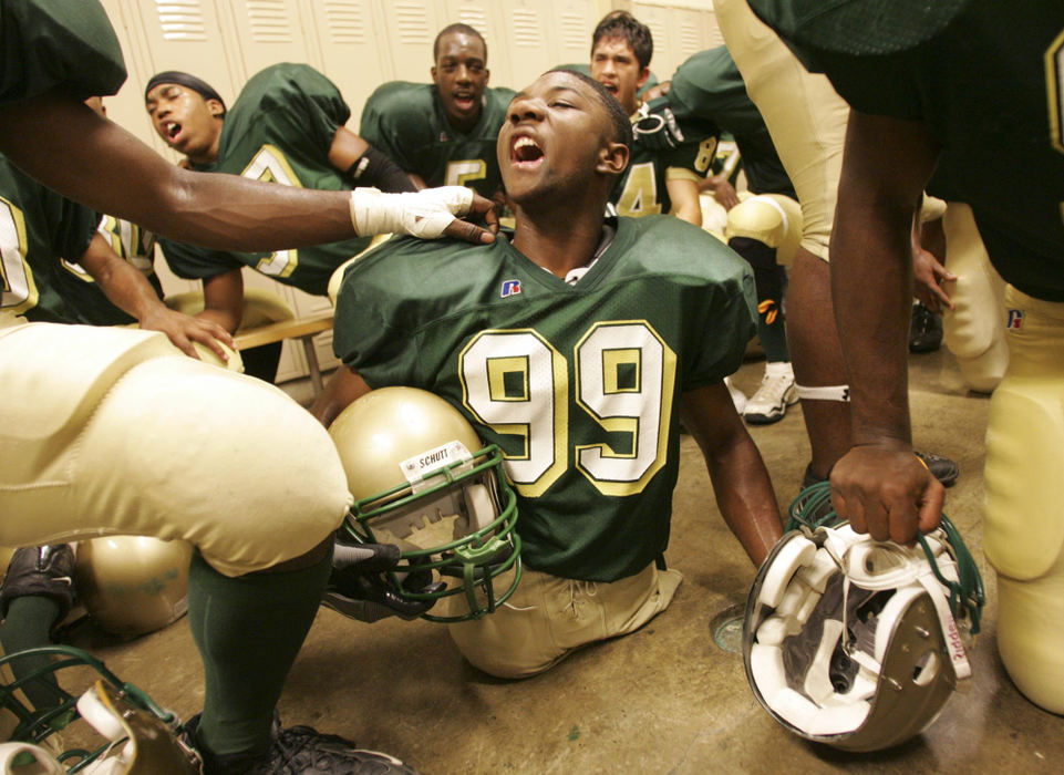 Award of Excellence, Sports Picture Story - Jim Witmer / Dayton Daily NewsColonel White's Bobby Martin is in the midst of teammates as they chant a spirited response to a coaches' inspirational speech in the locker room before a game with Dunbar.