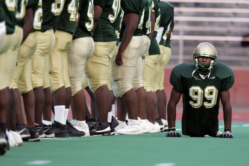 Award of Excellence, Sports Picture Story - Jim Witmer / Dayton Daily NewsColonel White's Bobby Martin walks behind temmates as they line up on the field prior to a  game vs. Dunbar. 