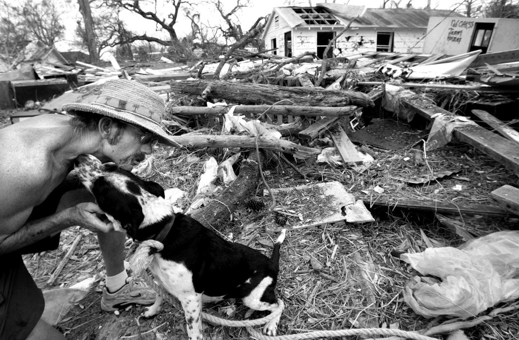 First place, Team Picture Story - JOSHUA GUNTER / The Plain DealerJoseph Brooks,41, cares for Two Bit, a dog he rescued during hurricane Katrina, a stones throw from the ocean behind the Grand Casino in Biloxi, Mississippi, September 05, 2005. 