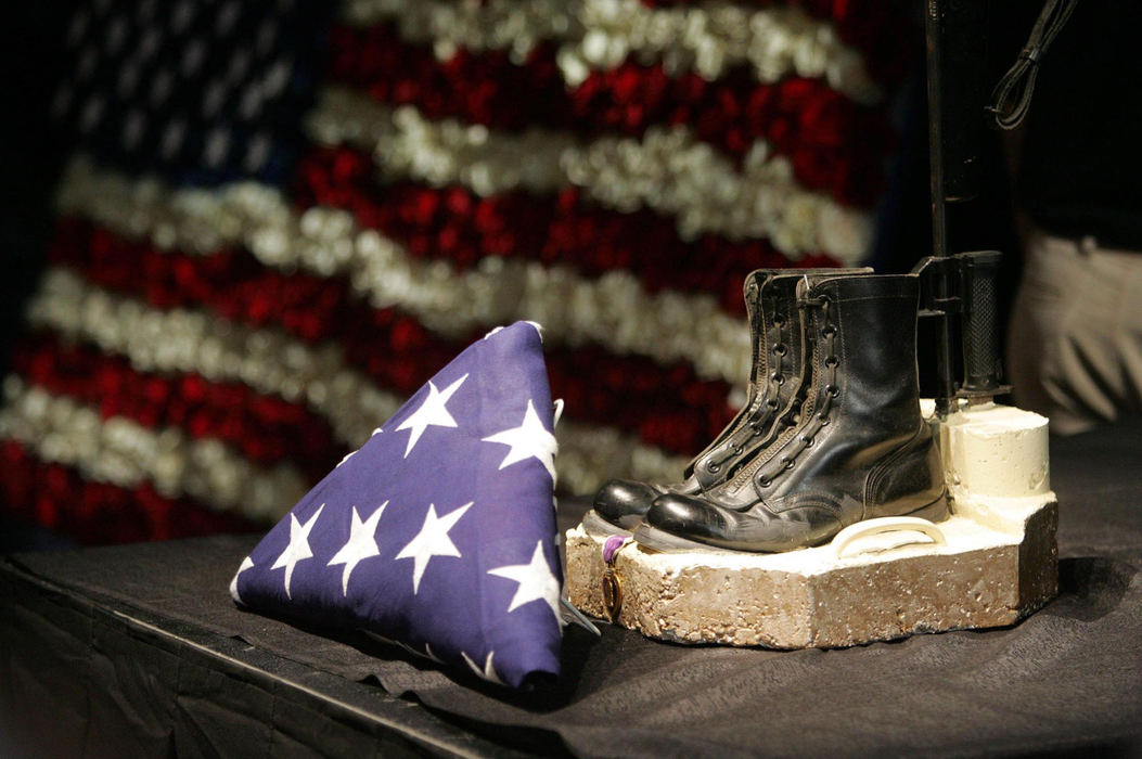 Second Place, Team Picture Story - scott shaw / The Plain DealerA pair of combat boots and a rifle are displayed on the stage at a public memorial service at the I-X Center in Brook Park on Aug. 8, 2005. Thousands attended to honor the fallen Marines. 