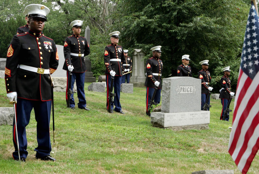 Second Place, Team Picture Story - Mike Levy / The Plain DealerAwaiting the arrival of a fallen brother, a Marine honor guard stood stoically in the Tallmadge Cemetery. 