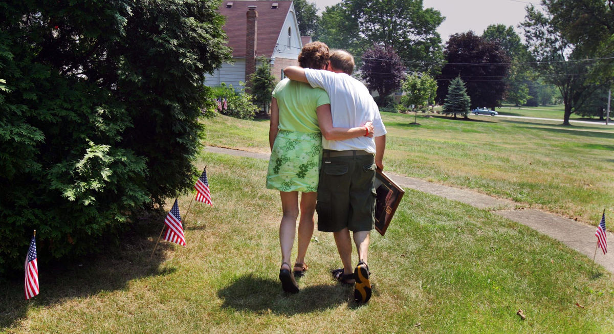 Second Place, Team Picture Story - Gus Chan / The Plain DealerEdie and Dan Deyarmin Sr. embrace as they make their way to the front of their Tallmadge home August 3, 2005, after addressing the media. Deyarmin's son Dan Jr. was killed when he was killed in an ambush in Haditha. 