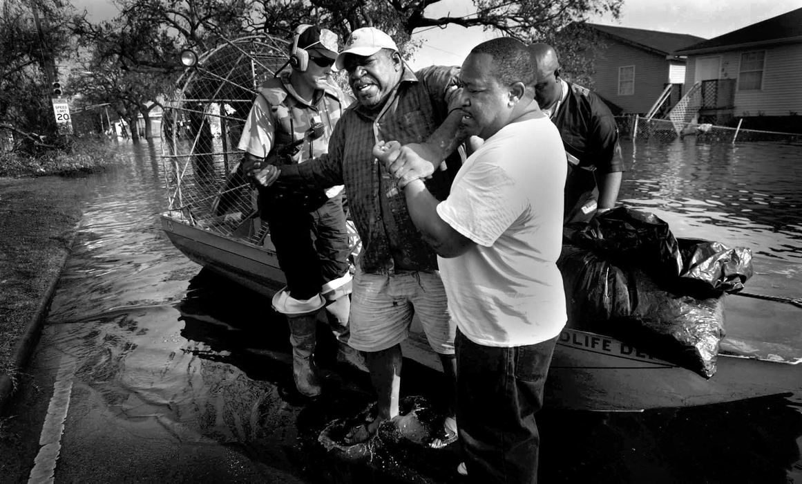 First place, Team Picture Story - DALE OMORI / The Plain DealerDwight Williams, 59, is helped out of an air boat after being taken back to his home the flooded out Arabi section of New Orleans to retrieve medication, Sept. 4, 2005.