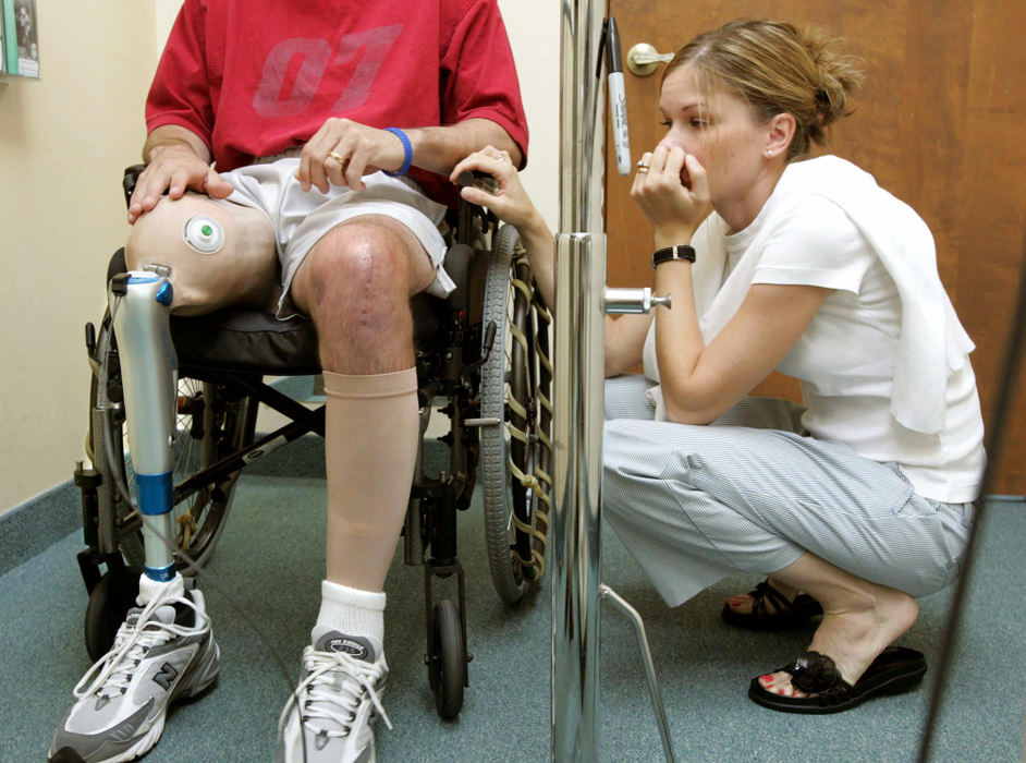 Third Place, Team Picture Story - David I. Andersen / The Plain DealerBarb waits at Ryan's side just before he took his first steps at Manuel Garcia Prosthetic and Orthotic Center in Strongsville almost three months after the accident.  The high-tech prosthetic is made of carbon graphite with a microprocessor in its shaft.