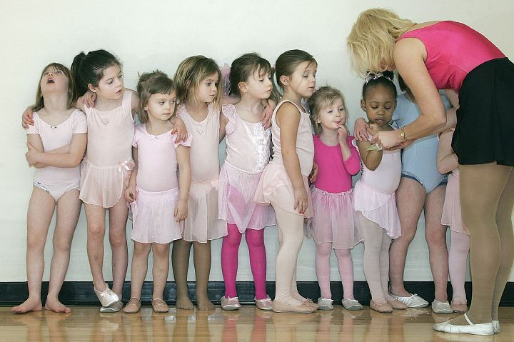 Third Place, Enterprise Feature - Neal C. Lauron / The Columbus DispatchDance instructor Tami Kelly rewards anxious mini ballerinas, from the Basic Ballet class at the Grove City YMCA, stickers after their class, March 14, 2006. The dancers got to pick out the sticker and have them stuck to their cheek or wrists after the class. Not all of the tiny dancers were patient for the reward.