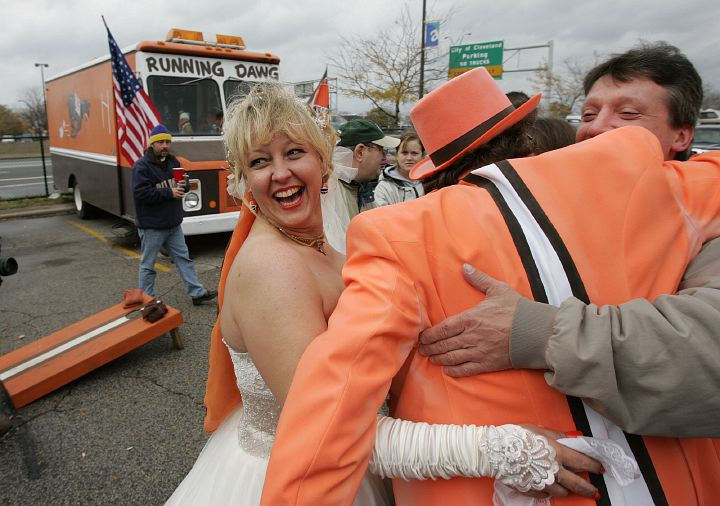 Award of Excellence, Enterprise Feature - Joshua Gunter / The Plain DealerCleveland Browns fans and newlyweds Bruce and Dawn MacLaren celebrate their wedding in true Cleveland tailgating style October 22, 2006 at the Municipal Parking Lot in Cleveland. The two were wed before the start of the Browns game with their fellow fans- who they call their second family. 