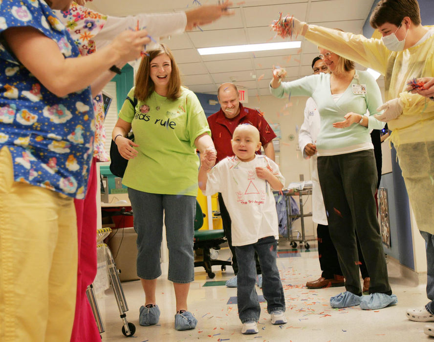 First Place, Feature Picture Story - John Kuntz / The Plain DealerDakota Bihn walks with her mother Julie and followed by dad, Ken, as she is showered with confetti by nurses and doctors who work in the 5200 floor at Duke Medical Center March 27, 2006 in Durham, NC upon her release.  