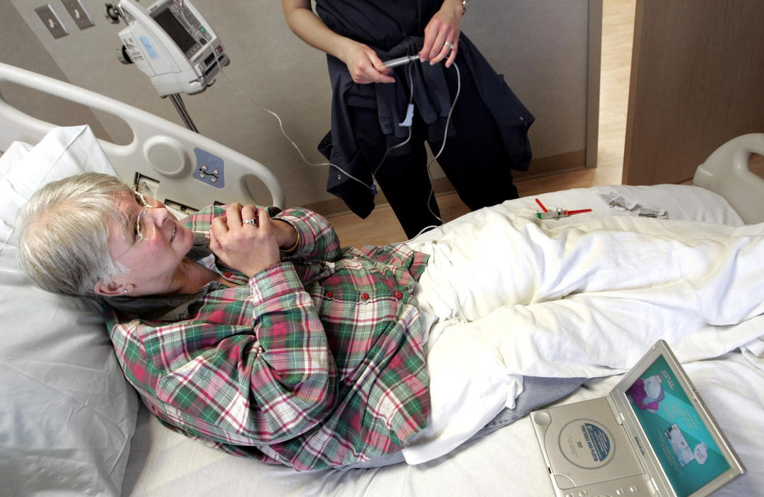 Second Place, Feature Picture Story - Chris Russell / The Columbus DispatchWhile the nurse begins to deliver her chemotherapy drugs, Audrey says a prayer.  The process takes hours and she brought a DVD player to help pass the time.  