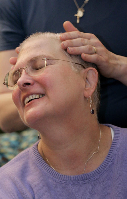 Second Place, Feature Picture Story - Chris Russell / The Columbus DispatchAudrey is all smiles as Lee rubs lotion on her newly shaved head after an elaborate ceremony in their living room to shave her head.  