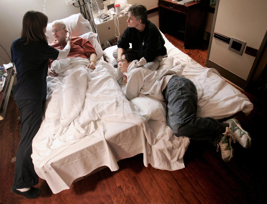 Second Place, Feature Picture Story - Chris Russell / The Columbus DispatchA nurse checks Audrey's temperature while Lee and Mary Orin look on from a fold out bed that Lee was using to stay overnight during Audrey's stay at the Arthur James Cancer Hospital. 