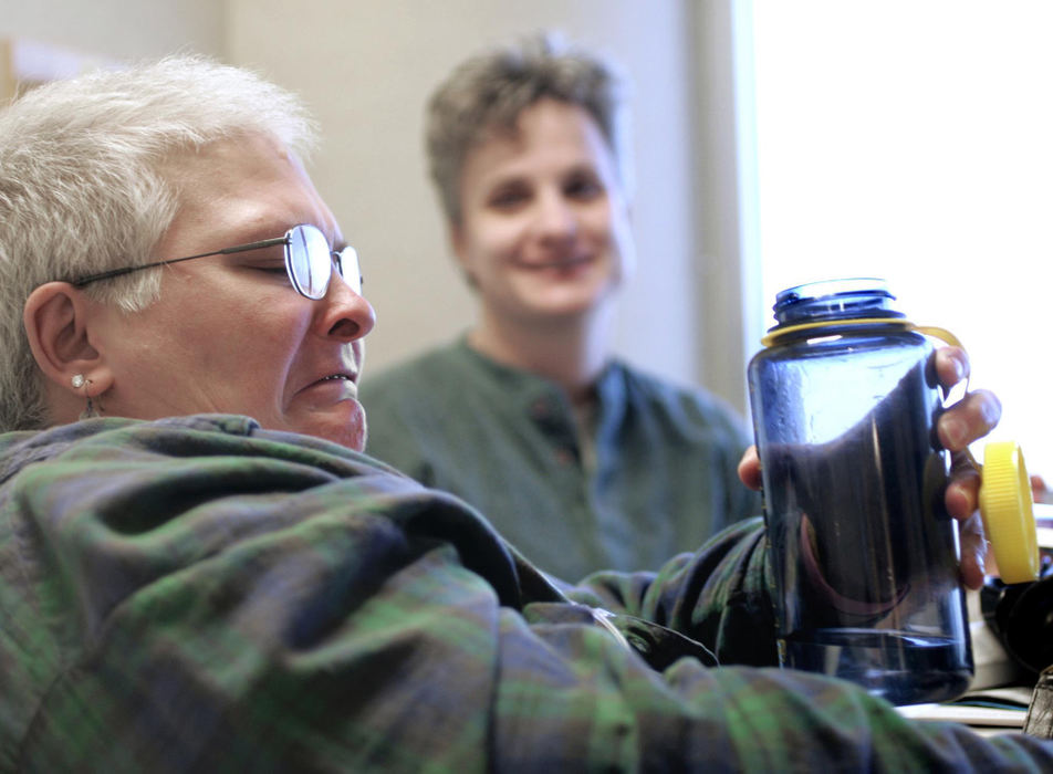 Second Place, Feature Picture Story - Chris Russell / The Columbus DispatchLee laughs in the background as Audrey reacts to the bitter taste of her meds.  Audrey had an extensive list of anti cancer drugs, anti depressants and painkillers she had to take in addition to her radiation and chemotherapy.  